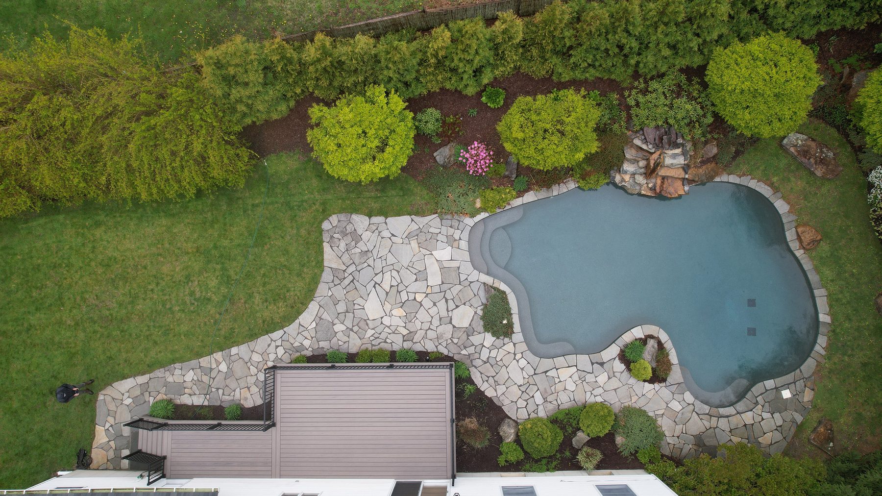 Aerial of a luxury Trex deck with pool and cable railing — Pinnacle Decking Hudson Valley NY