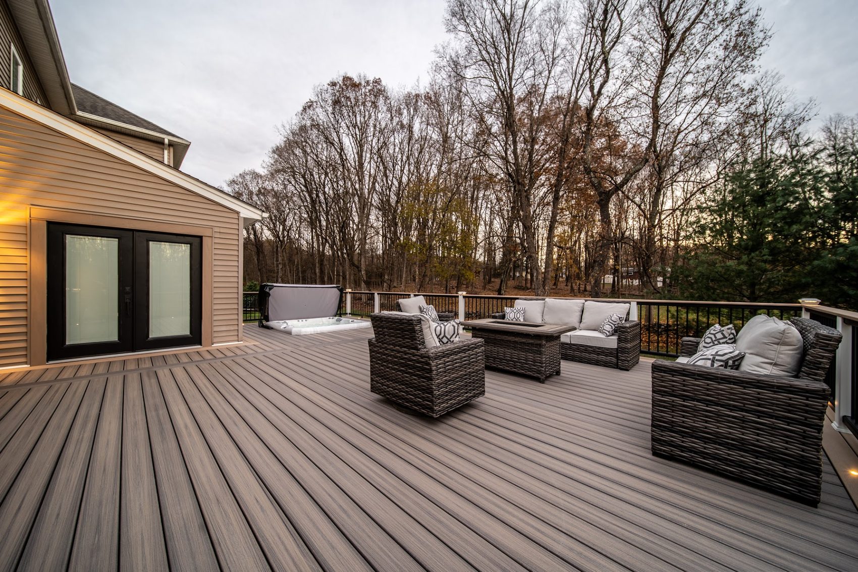 Elevated retreat outdoor living with fire pit and hot tub at dusk — Pinnacle Decking Hudson Valley NY