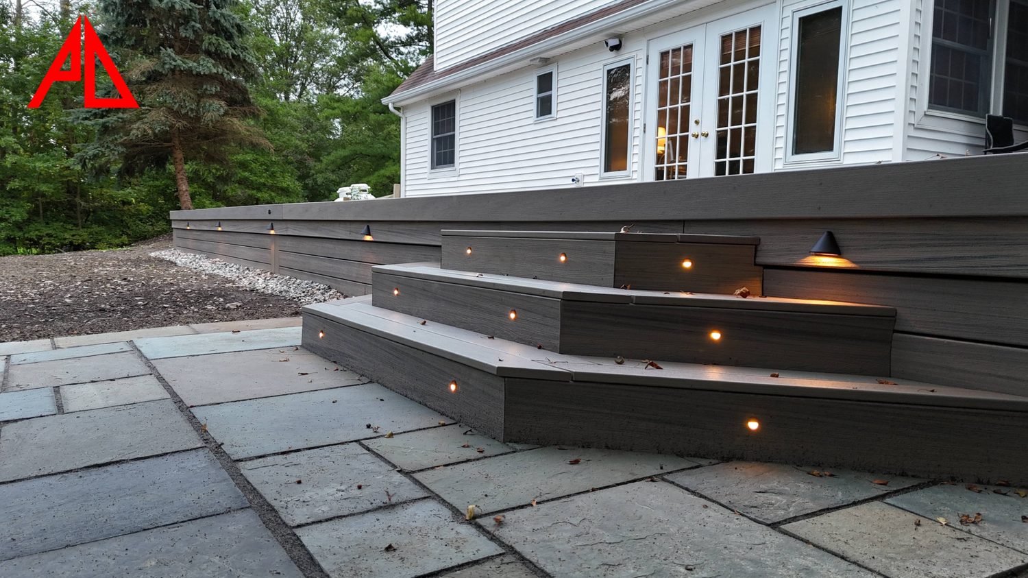 Composite deck steps with integrated LED lighting detail at night — Pinnacle Decking Hudson Valley NY