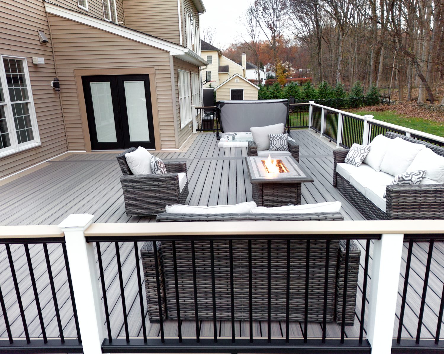 Fire pit seating viewed through aluminum cable railing on a composite deck — Pinnacle Decking Hudson Valley NY