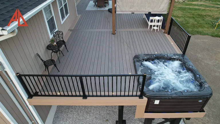 Deck with a hot tub and black aluminum railing
