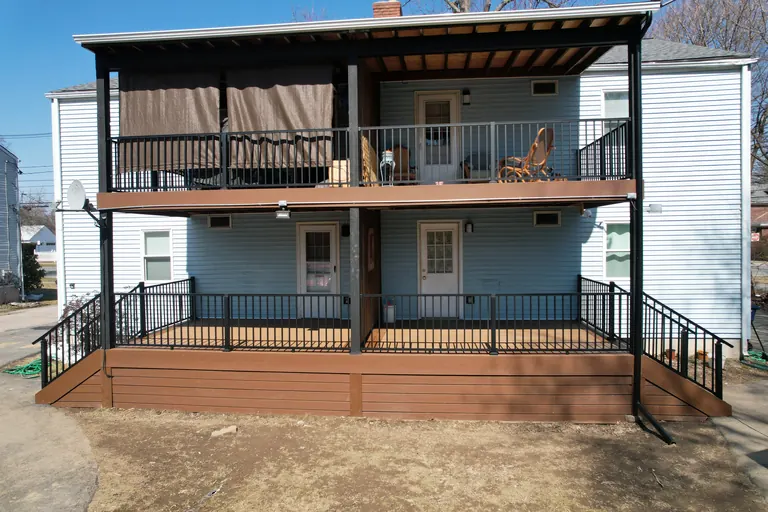 Two-story covered deck with black railing