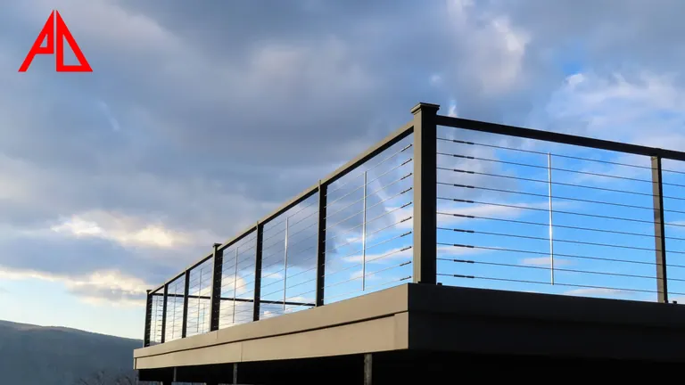 Cable railing along a raised deck edge against the sky
