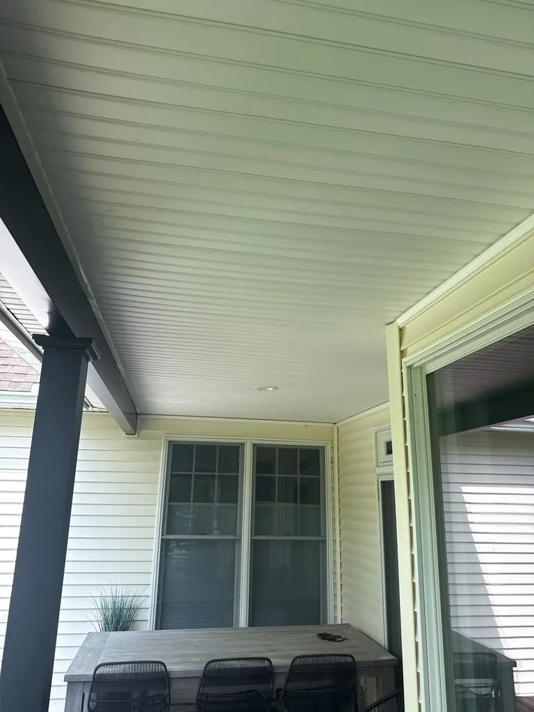 Wide side view of the house with a finished covered porch and open deck area, Hyde Park, NY