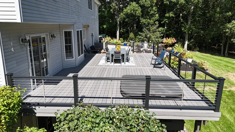 Covered porch corner, daytime, empty and clean with black railing