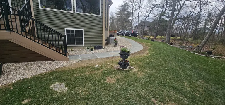 House corner with lower paver patio, daylight