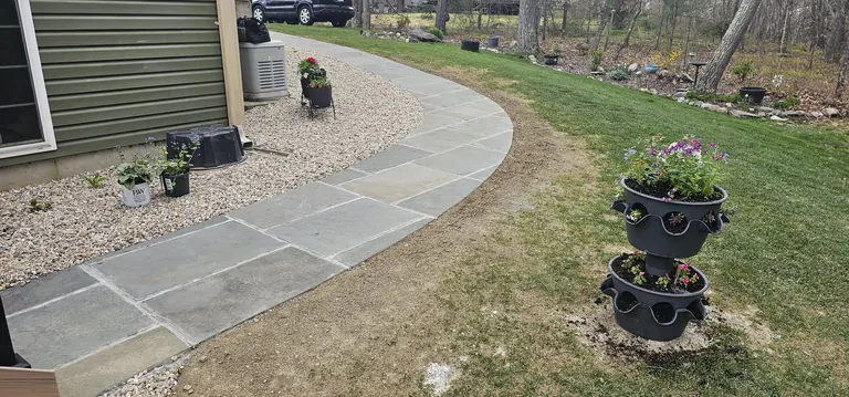 Curved paver walkway detail near the house