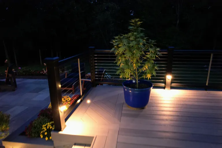 Same deck seen from the yard, diagonal picture-frame accent border and black cable rail, LaGrange, NY