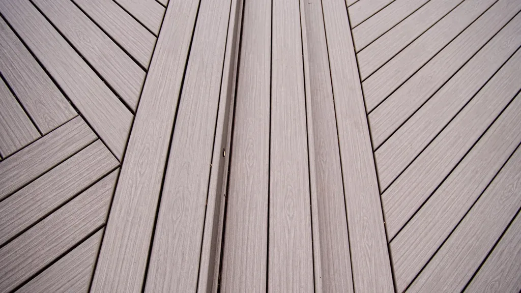 Close-up of a herringbone decking inlay pattern set into a Trex Signature deck field