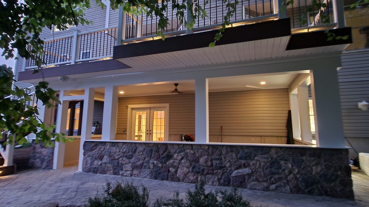 Finished under-deck living space with Trex RainEscape drainage and stone base — Pinnacle Decking Hudson Valley NY