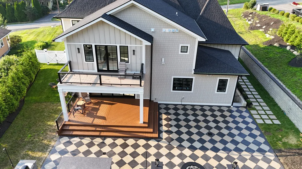 Aerial view of a deck above a black-and-cream checkerboard paver patio, second angle, Westchester County, NY
