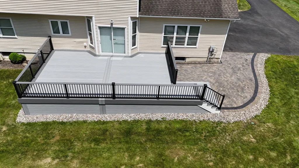 Aerial view of a composite deck with black railing on a landscaped summer property, Orange County, NY
