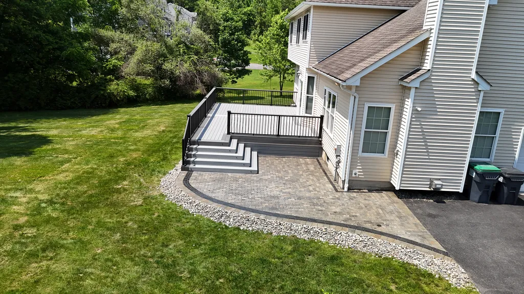 Aerial view of a deck with stairs down to a paver patio, summer, Orange County, NY