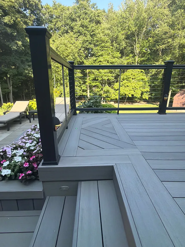 Cable railing post at a deck corner with a planter