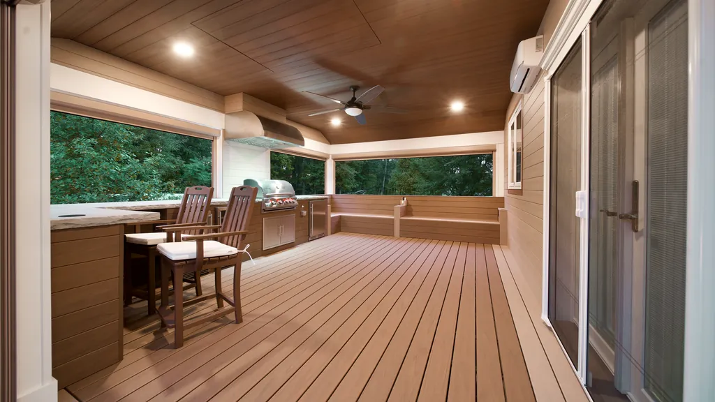 Covered outdoor kitchen with a built-in grill, wood plank ceiling, recessed lights and a ceiling fan