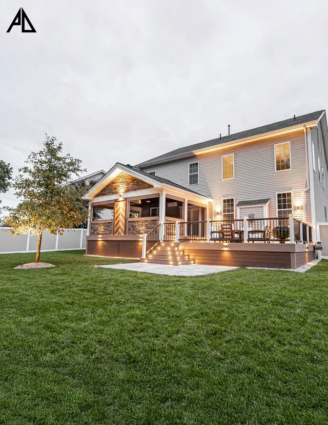 Covered porch and deck lit at dusk