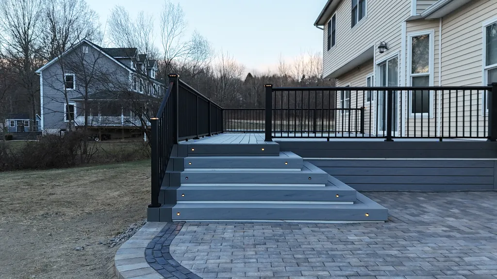 Deck and stairs at dusk with warm string and step lighting, Orange County, NY