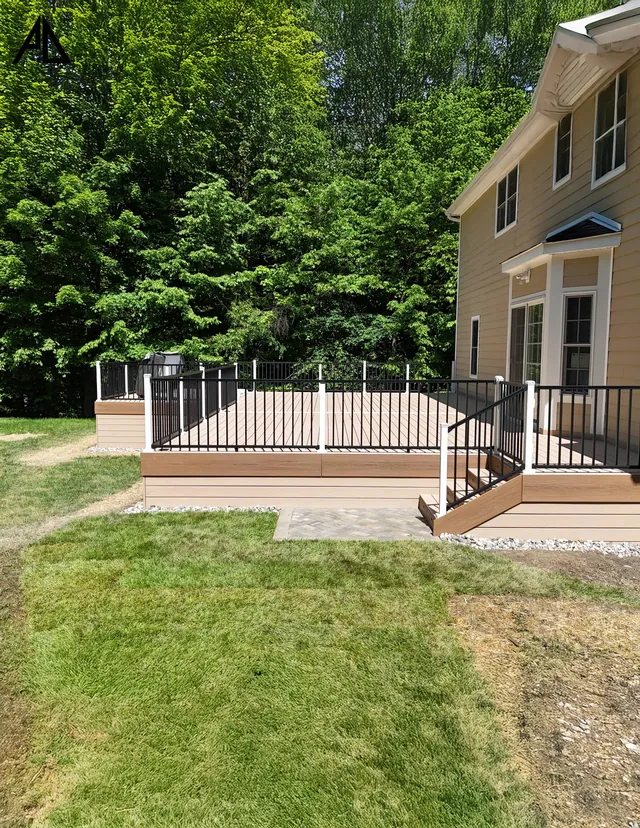 Deck with white railing and stairs down to the lawn