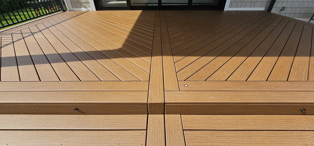 Close-up of diagonal-pattern composite decking boards with strong afternoon shadow lines, Westchester County, NY