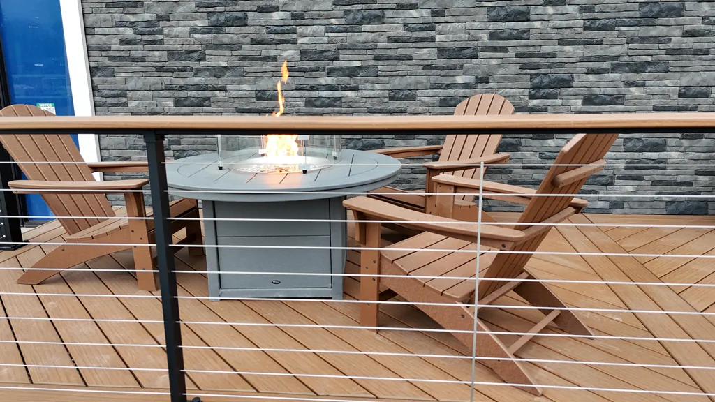 Display deck with a fire table, Adirondack chairs and cable railing