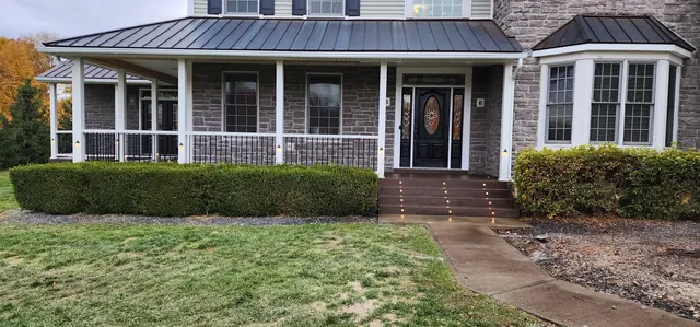 Covered front porch on a stone-front house