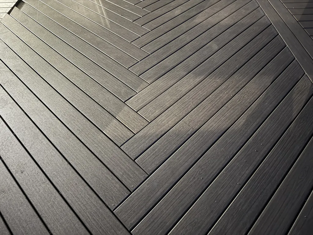 Close-up of a herringbone composite decking inlay, dark walnut tone, Putnam County, NY