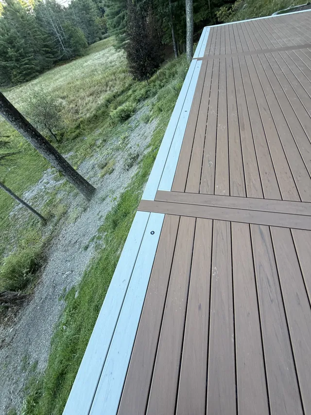 Picture-frame border and breaker board on a new Trex deck in Boiceville, plugs every foot along the frame, decking complete before railings
