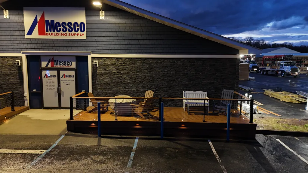 Storefront display deck at dusk with riser lights and cable railing