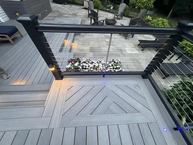 Herringbone inlay deck with cable railing and lit planters, LaGrange, NY