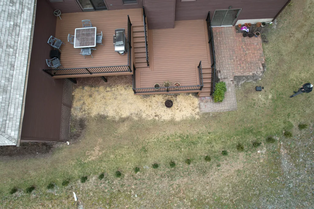 Wide view of the two-level composite deck and brick patio below, Dutchess County, NY
